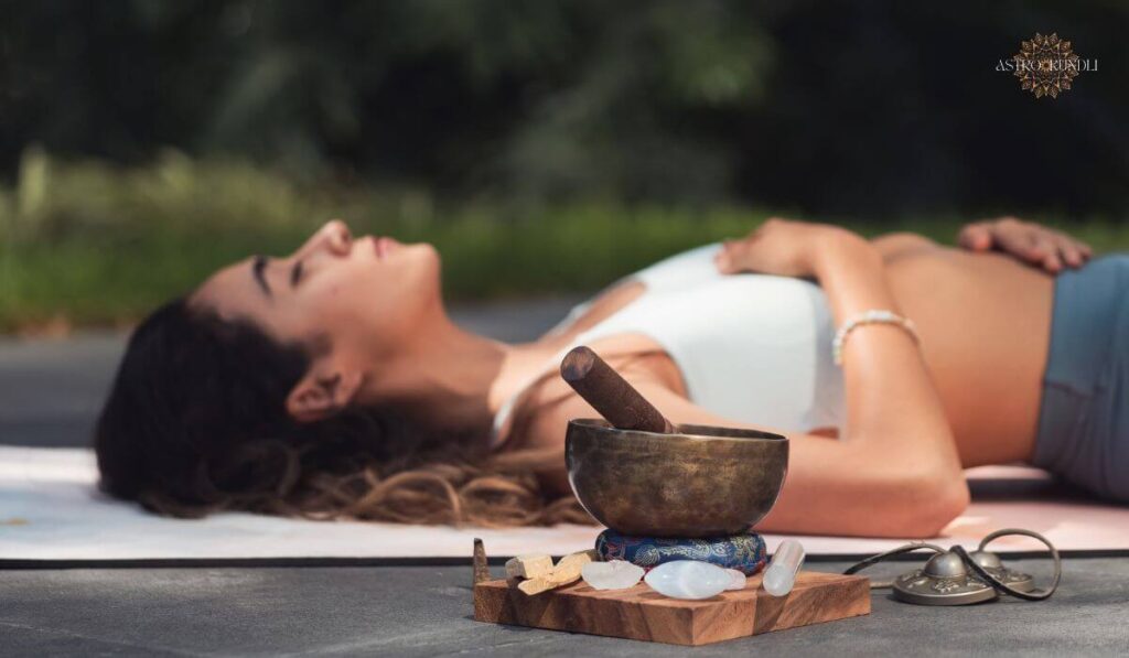 image of a woman meditating with a sound bowl next to her