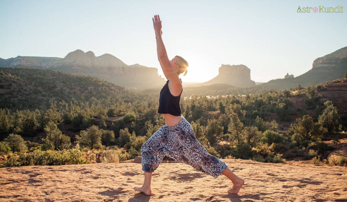 woman performing warrior yoga pose to activate solar plexus chakra